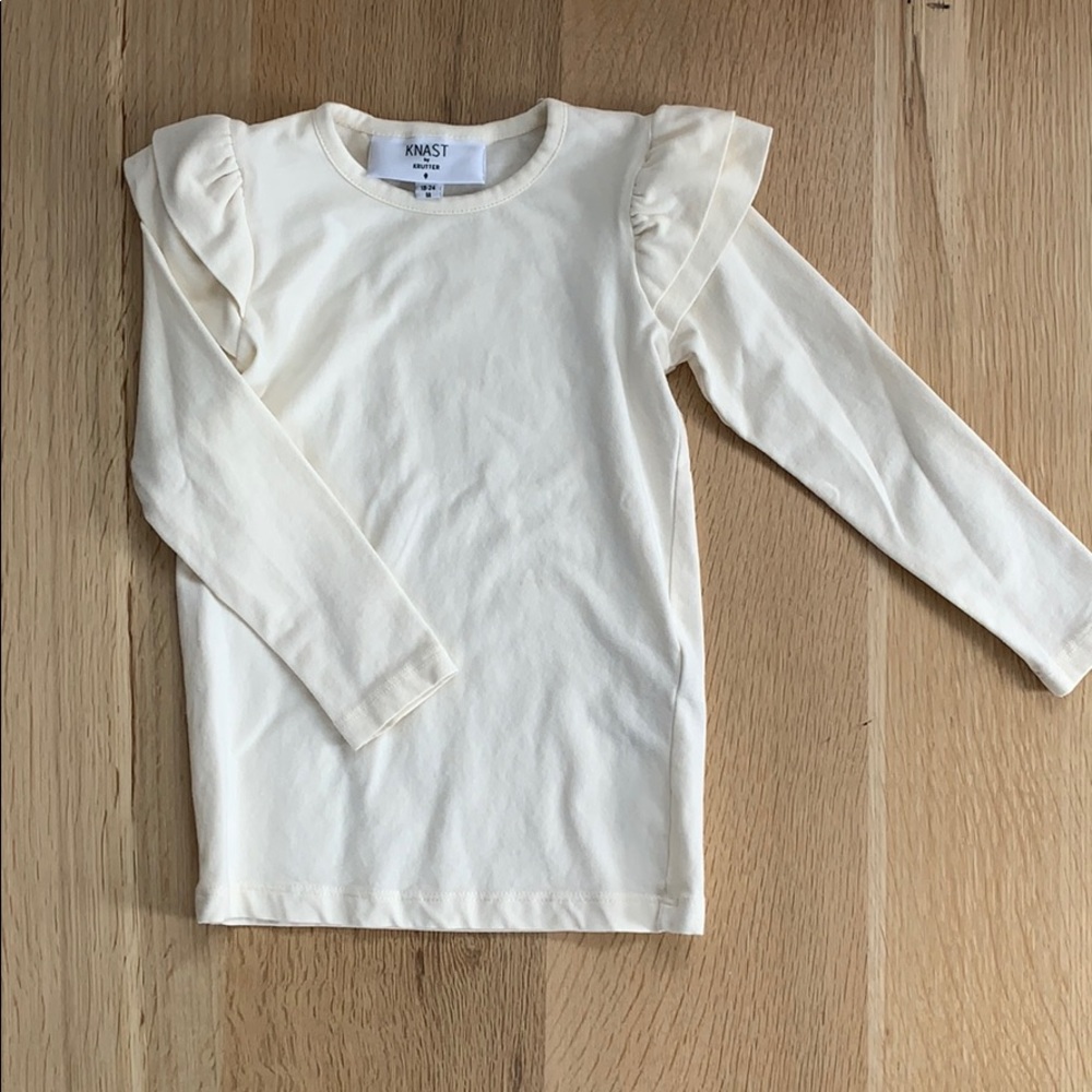 Cream long sleeve tee with shoulder detail.